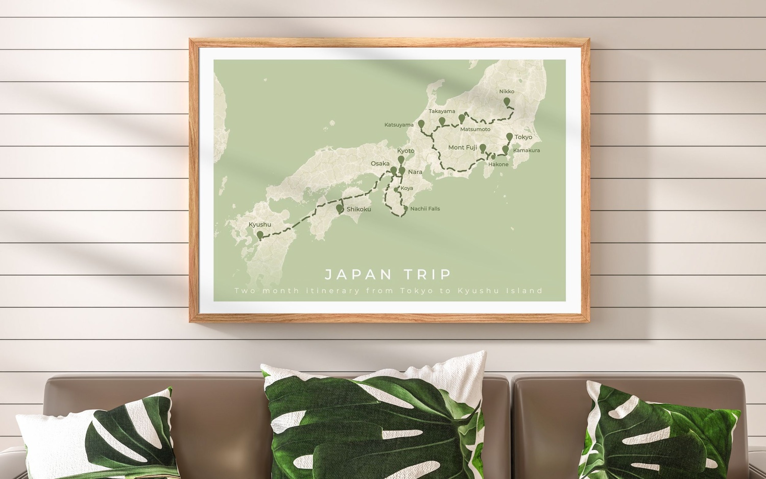 Framed poster showing a road trip itinerary in Japan, displayed in a green and light wood interior